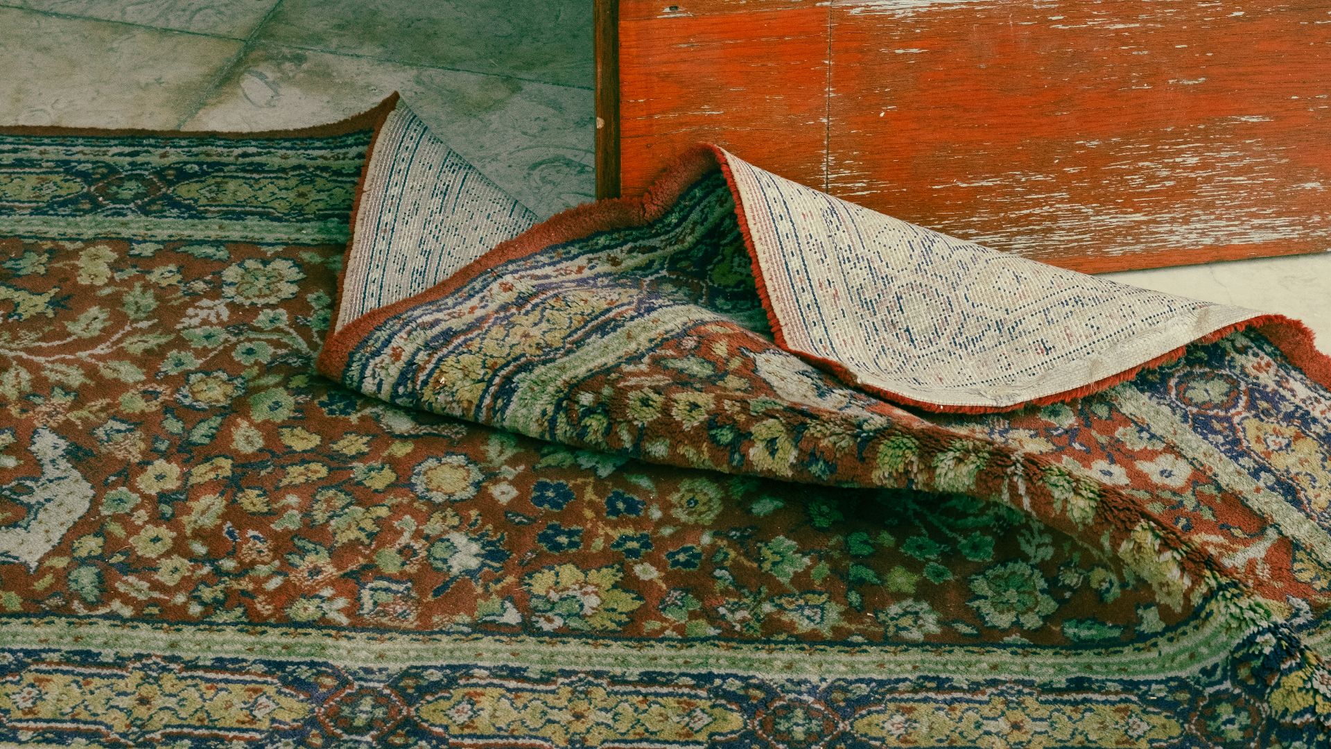 a carpet laying on the floor next to a door