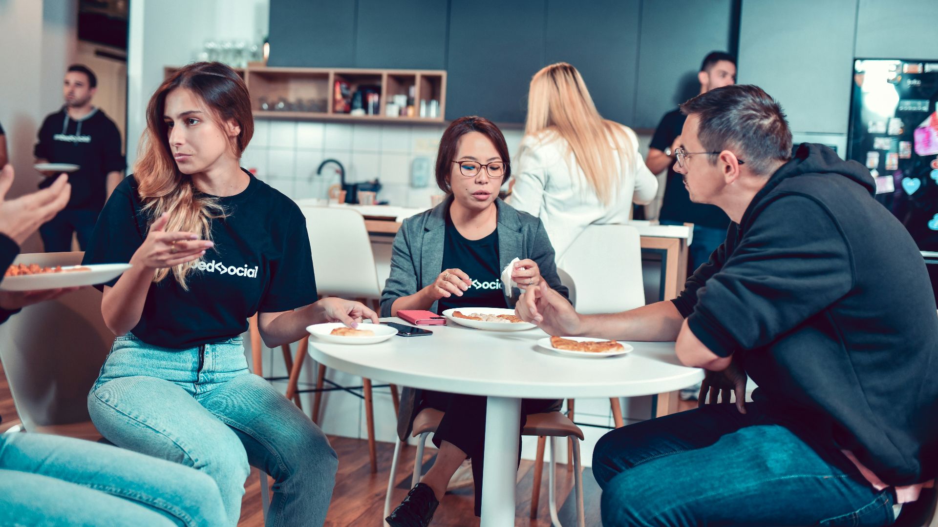 a group of people sitting around a table eating food
