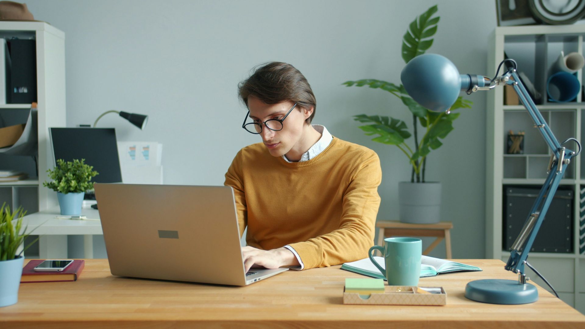 Man working on laptop at a desk.