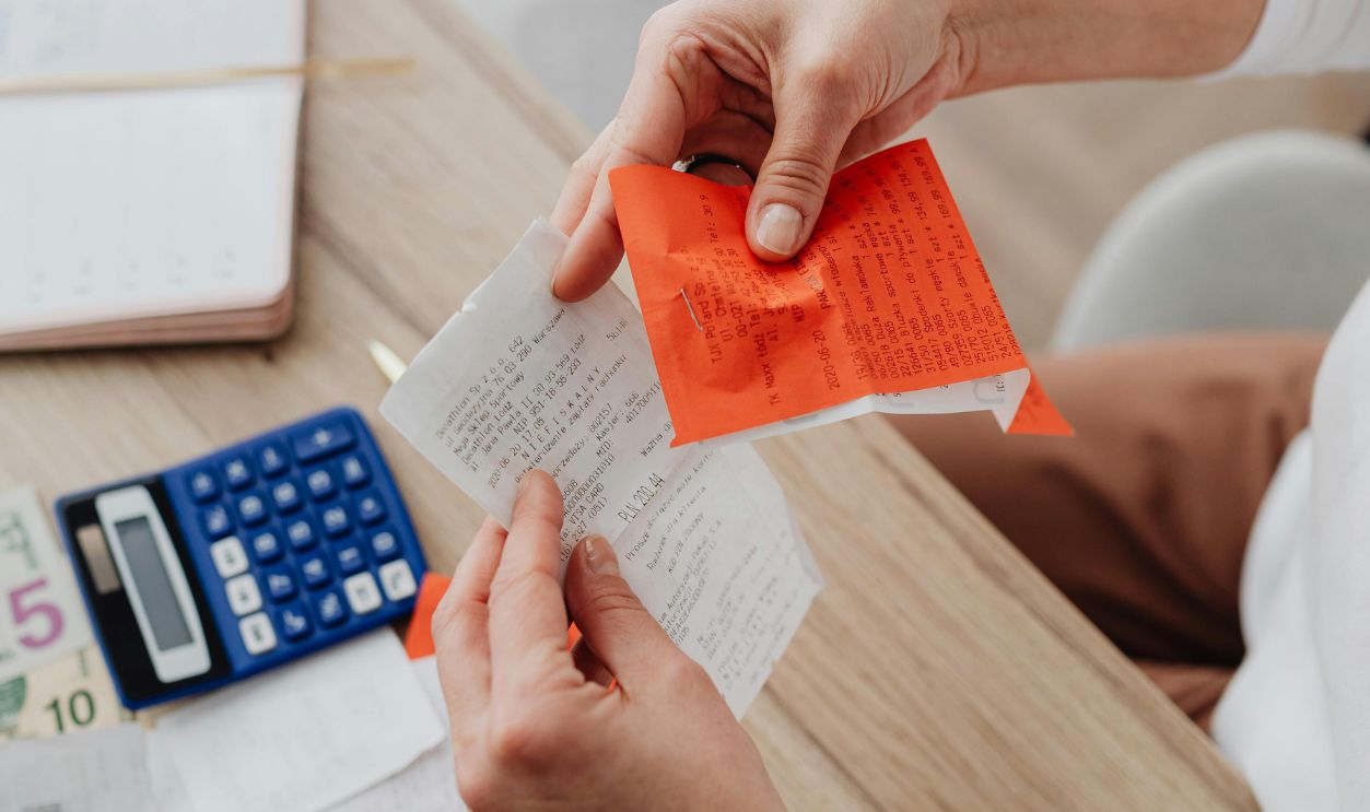Hands Holding Receipt and Notes