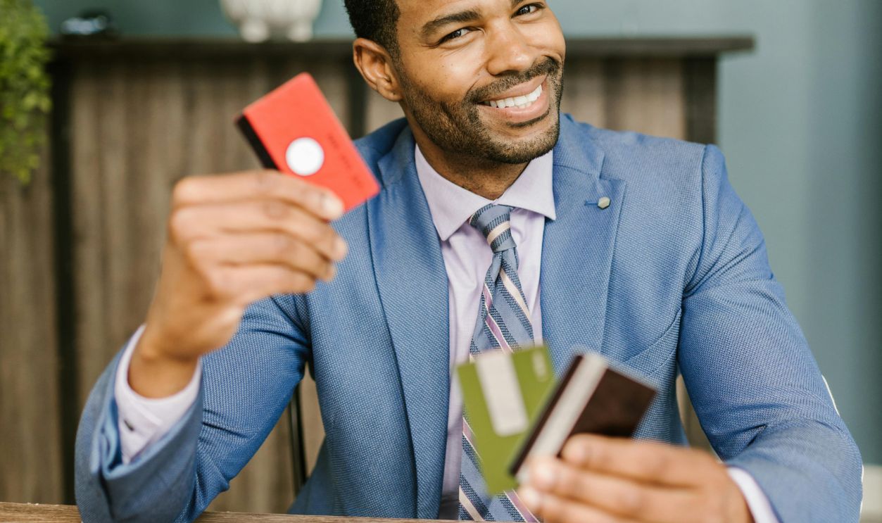 A Man in a Suit Holding Credit Cards