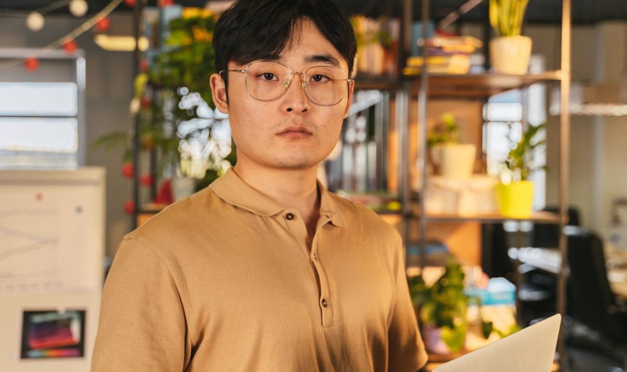 Man Wearing Brown Polo Shirt and Eyeglasses