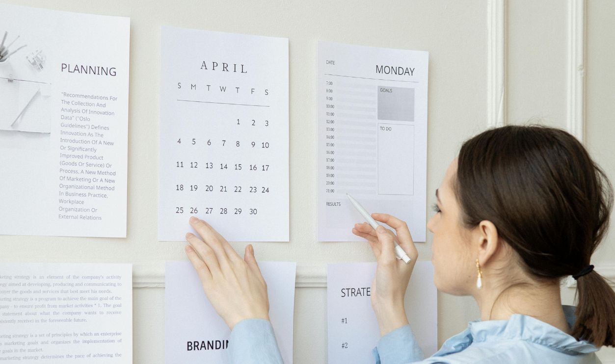 Woman in a Blue Top Looking at Paper