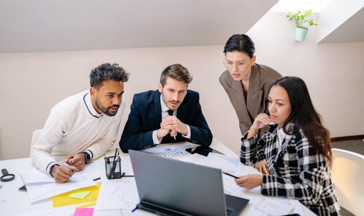 A Group of Businesspeople Looking at a Laptop Screen
