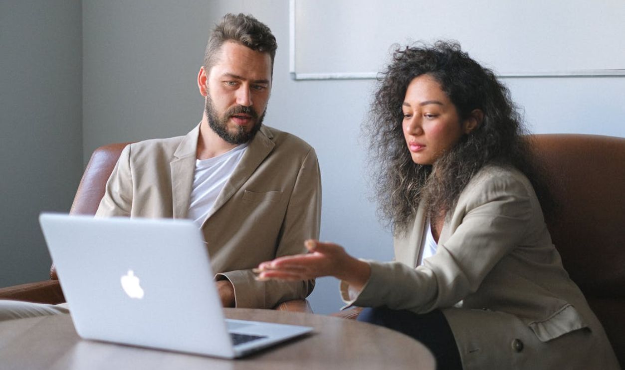 Focused man working with female colleague in office