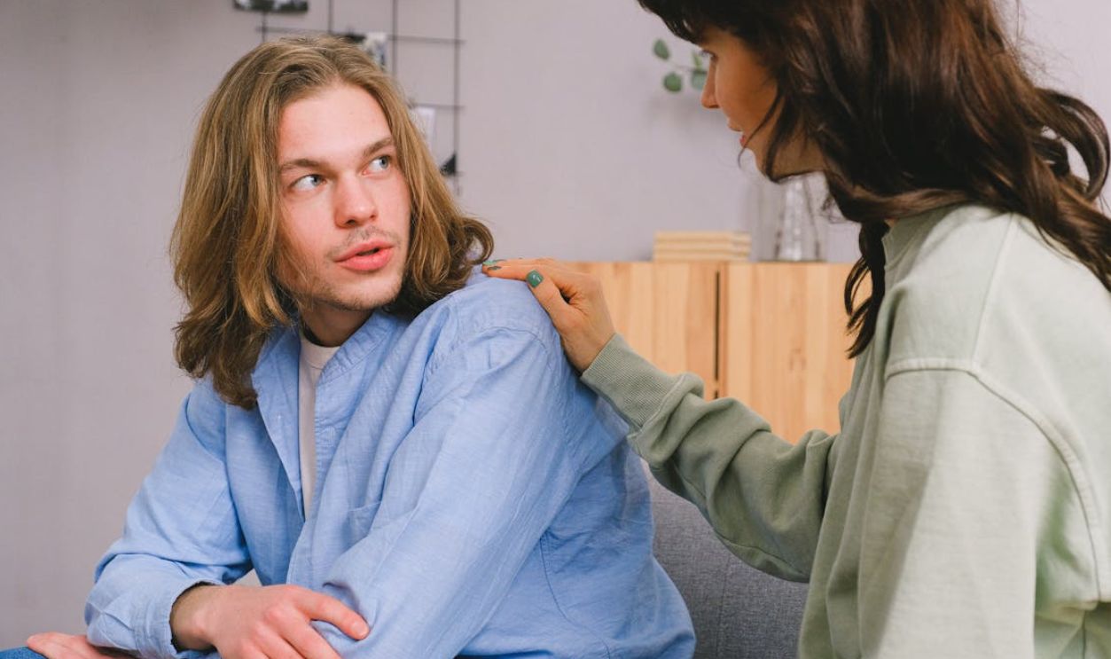 Woman talking with male in light room