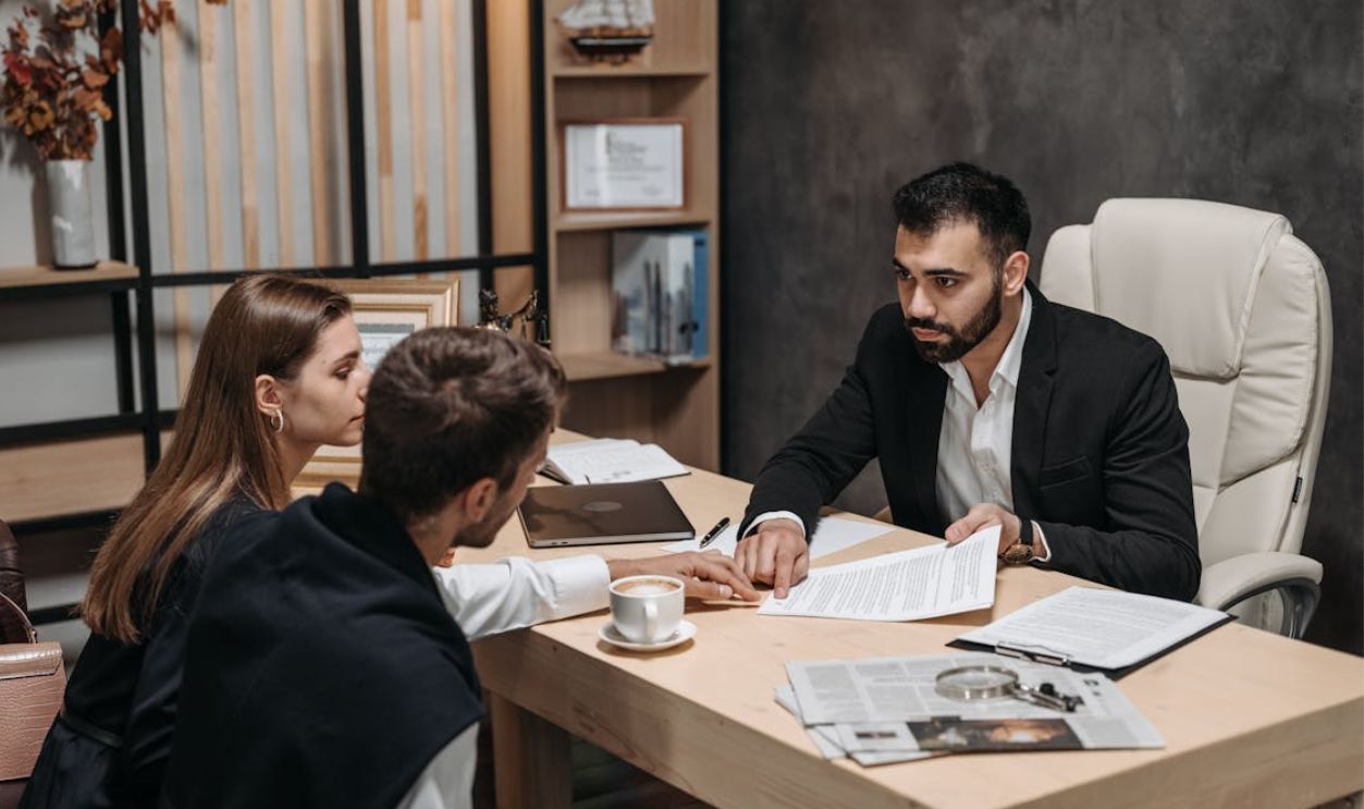 A Man in Black Suit Talking to His Clients