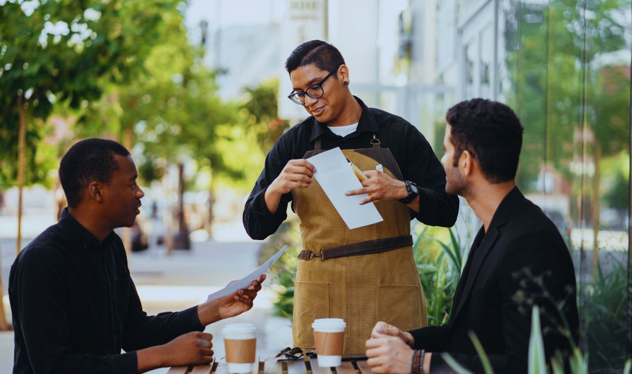 Waiter handing out the Menus for the Customers