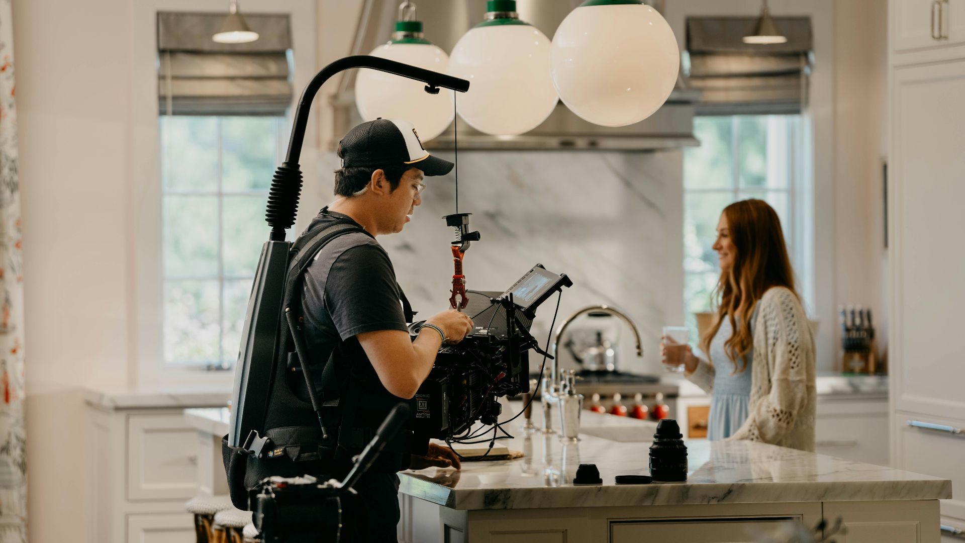 a man standing in a kitchen next to a woman