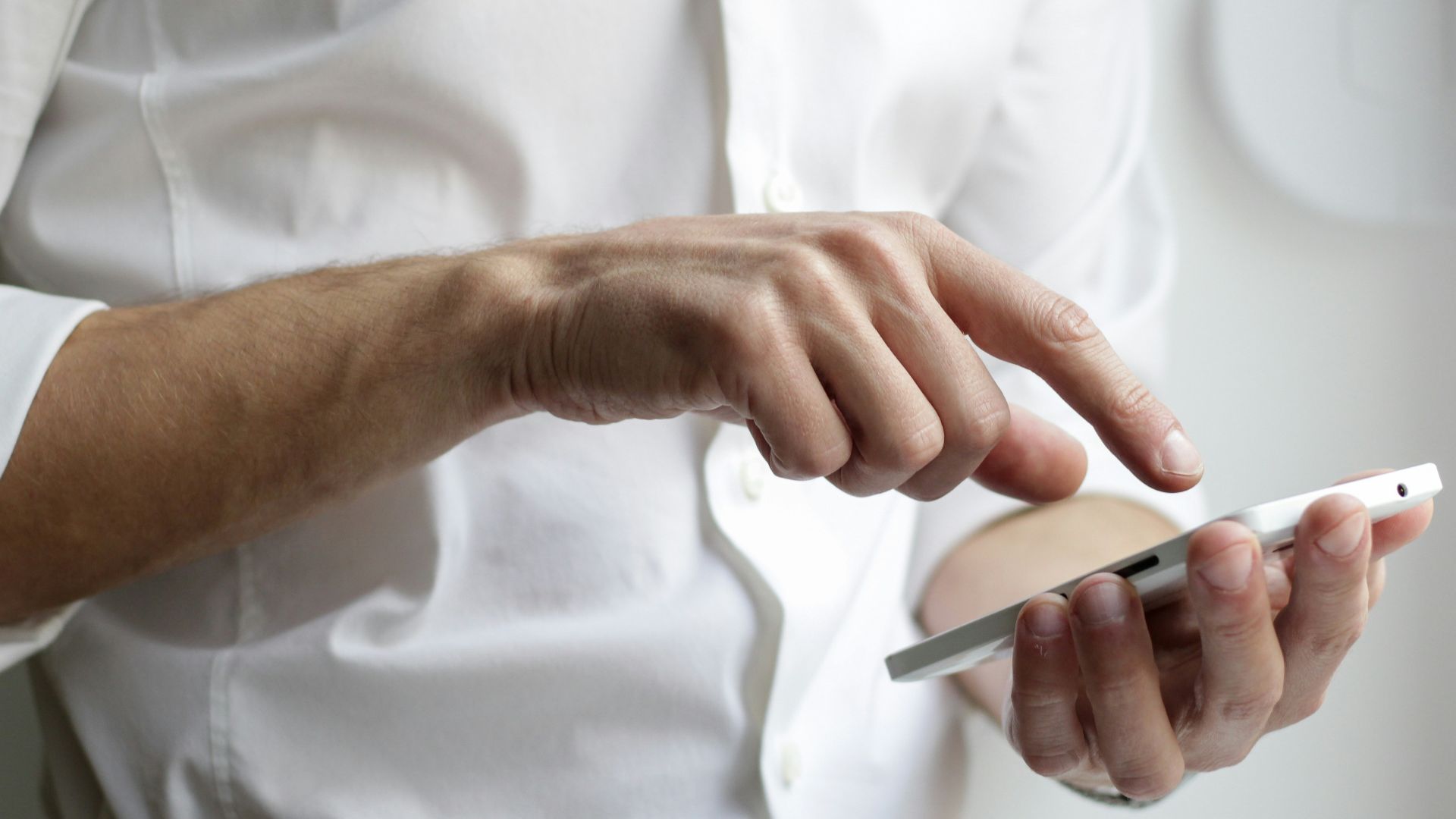 person holding white Android smartphone in white shirt