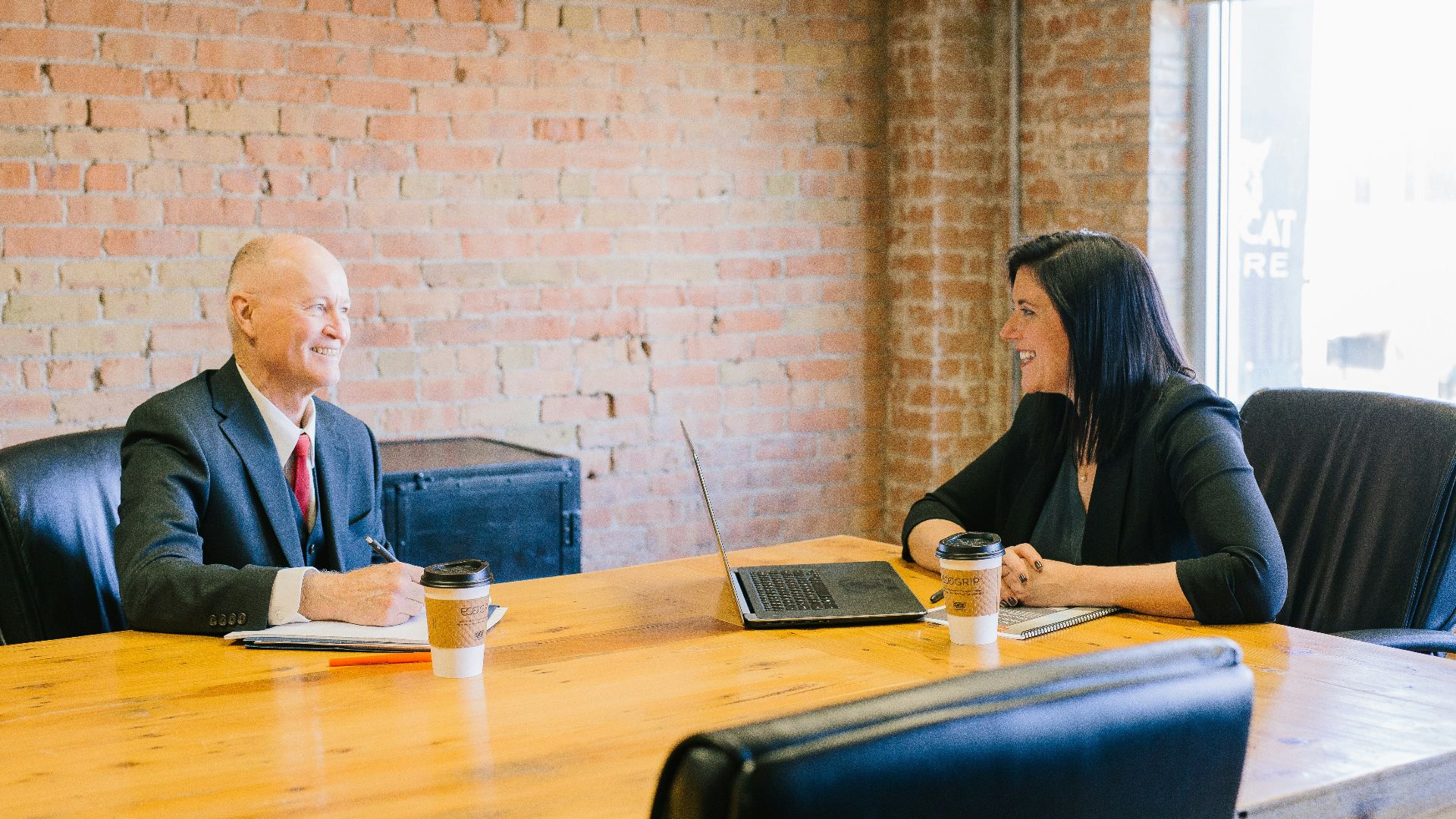 man and woman talking inside office