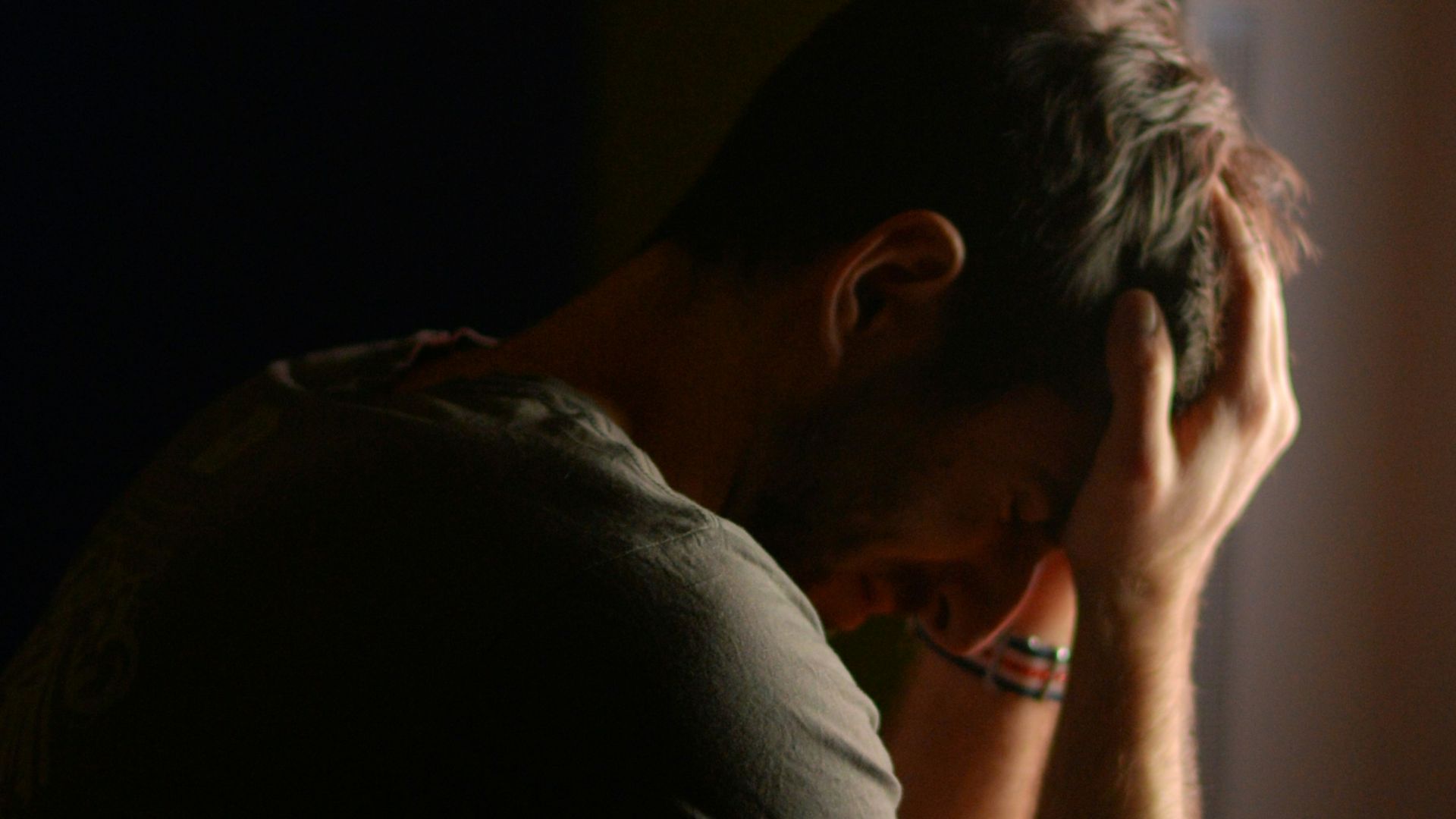 a man sitting at a desk in front of a computer