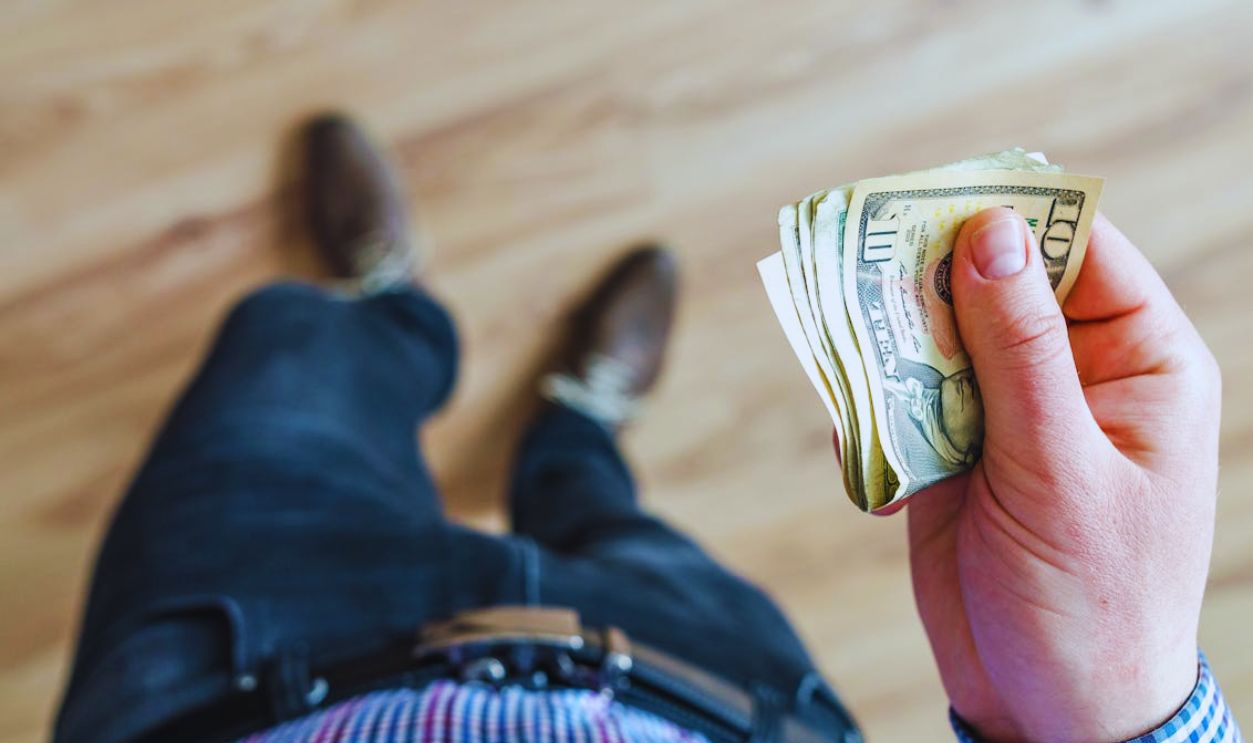 Man Holds 10 U.s Dollar Banknote