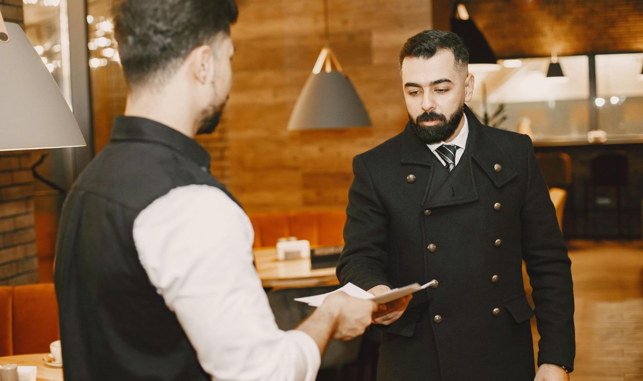 Waiter Handing Man RestMenu