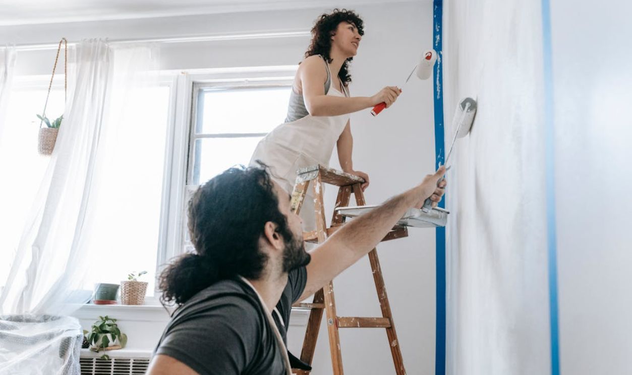 Couple Painting A Wall