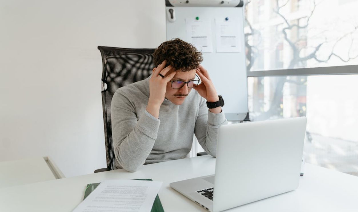 Man in Gray Sweater Sitting on Chair