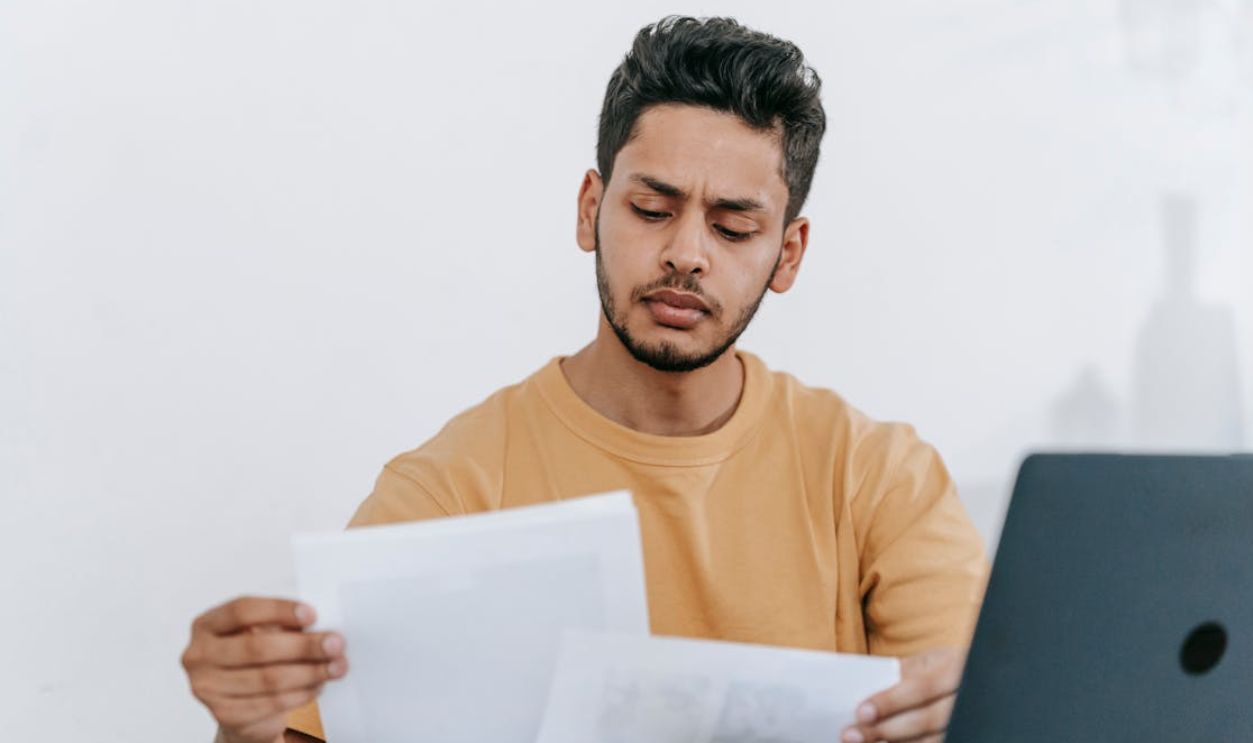 Man looking through documents at workplace