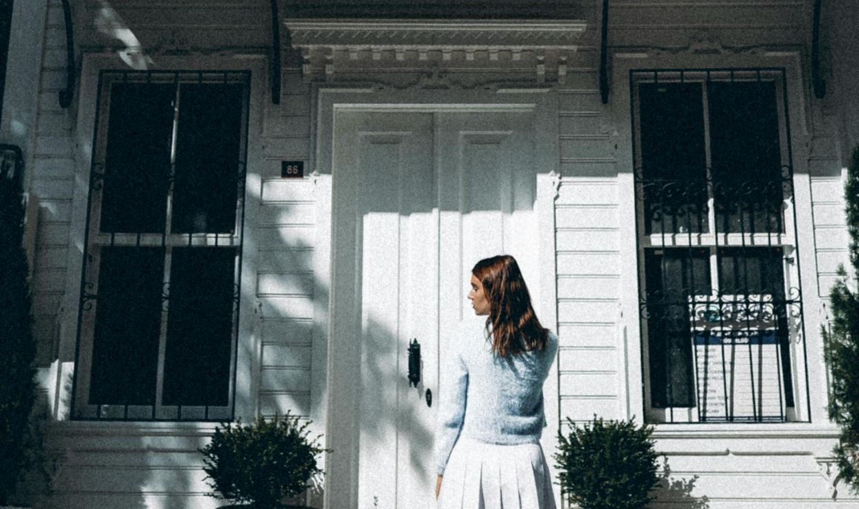 A Woman Standing Outside a House