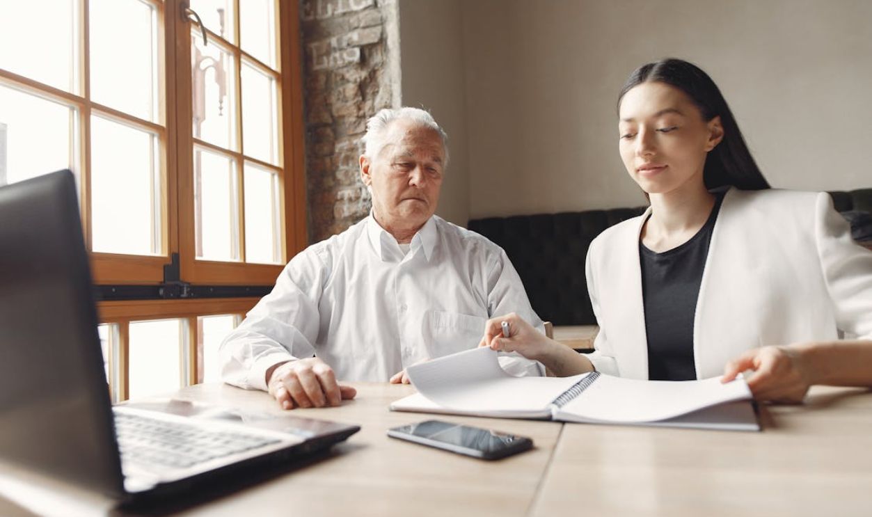 Concentrated coworkers of different ages working together in modern workspace