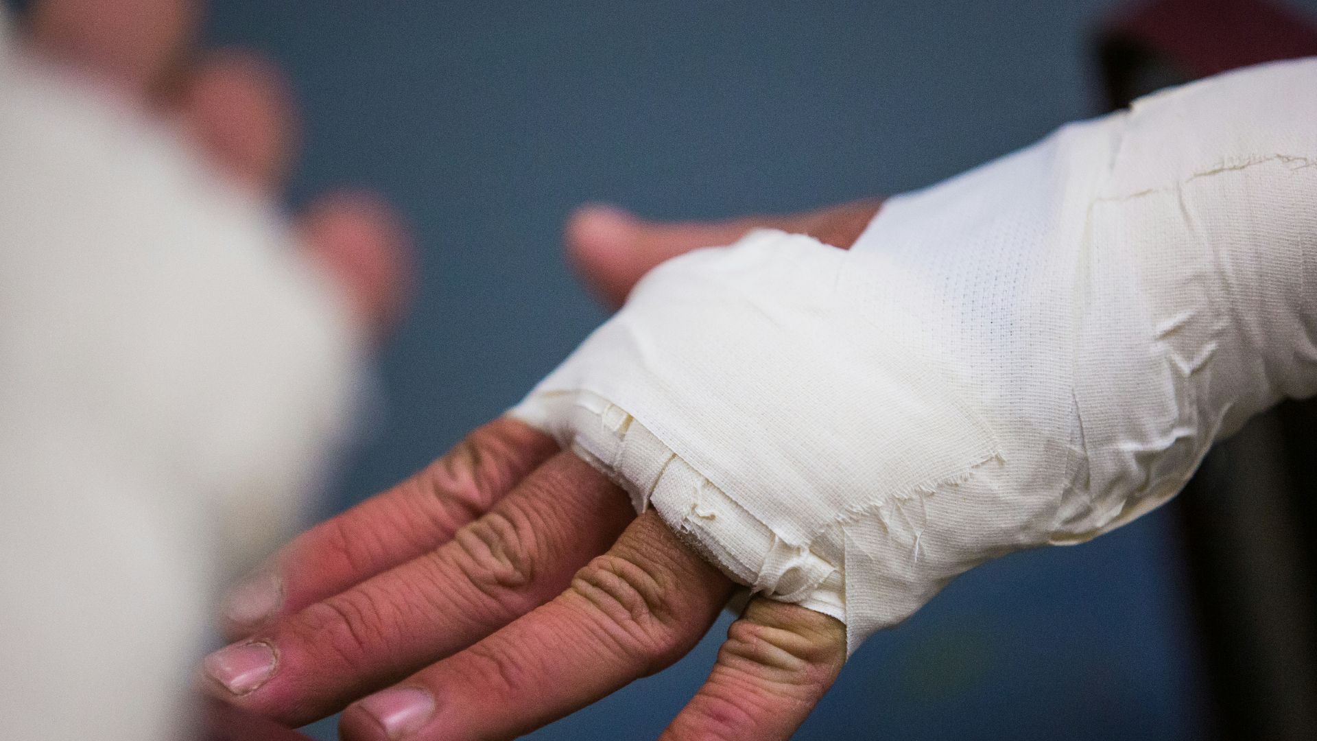 person with white bandage on hand