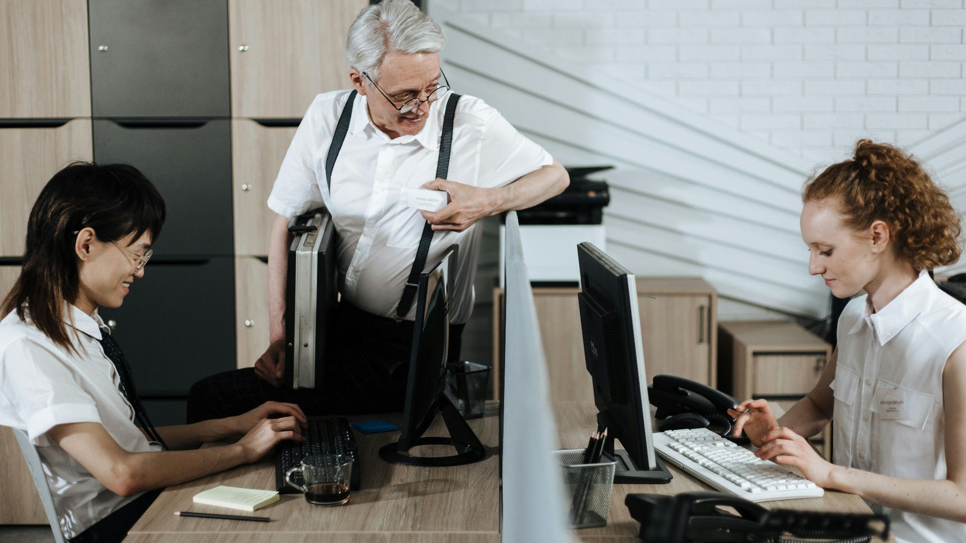 Group of diverse office workers collaborating at their desks. Professional teamwork setting.