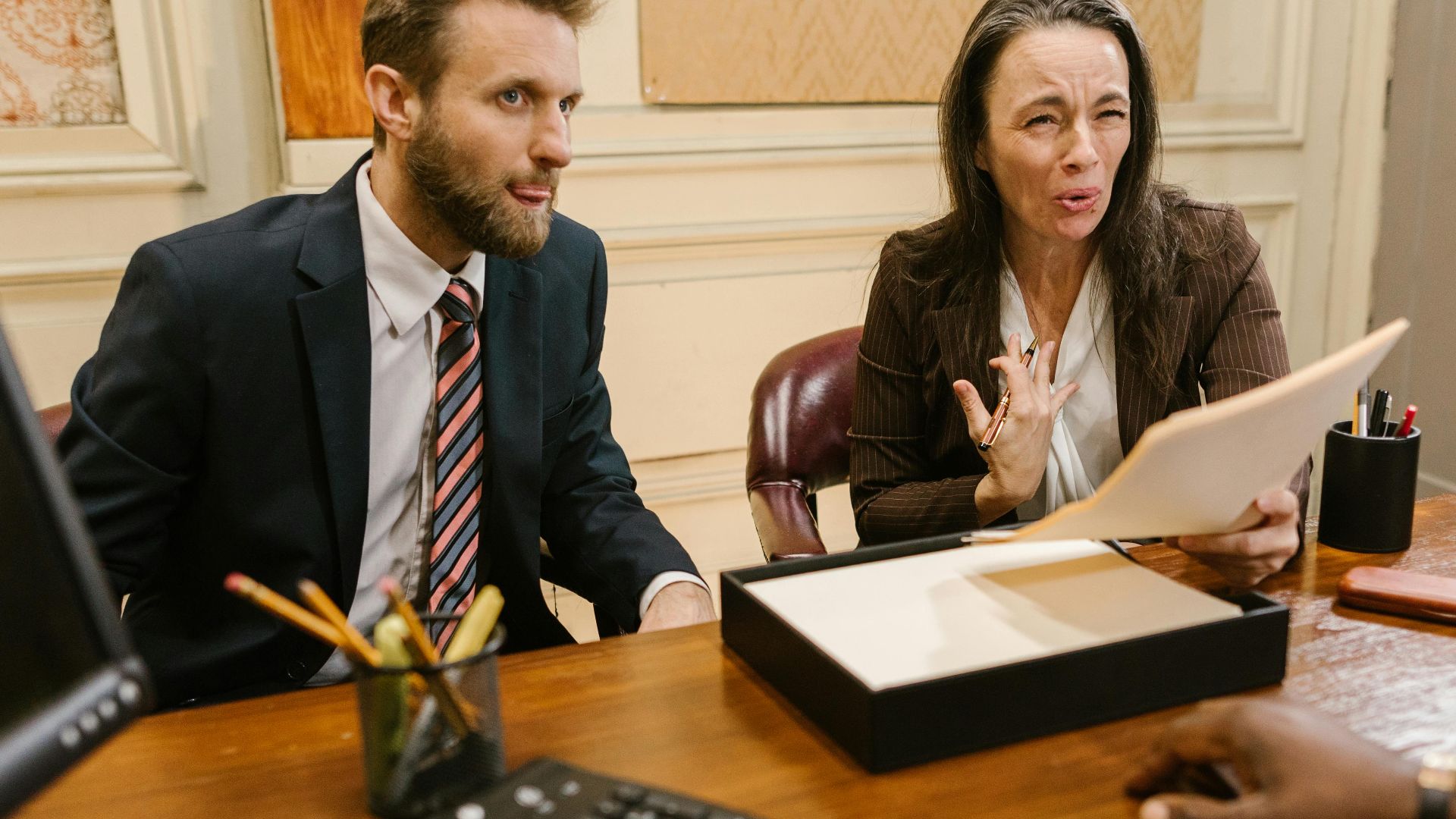 Lawyers discussing legal documents in a professional office setting.
