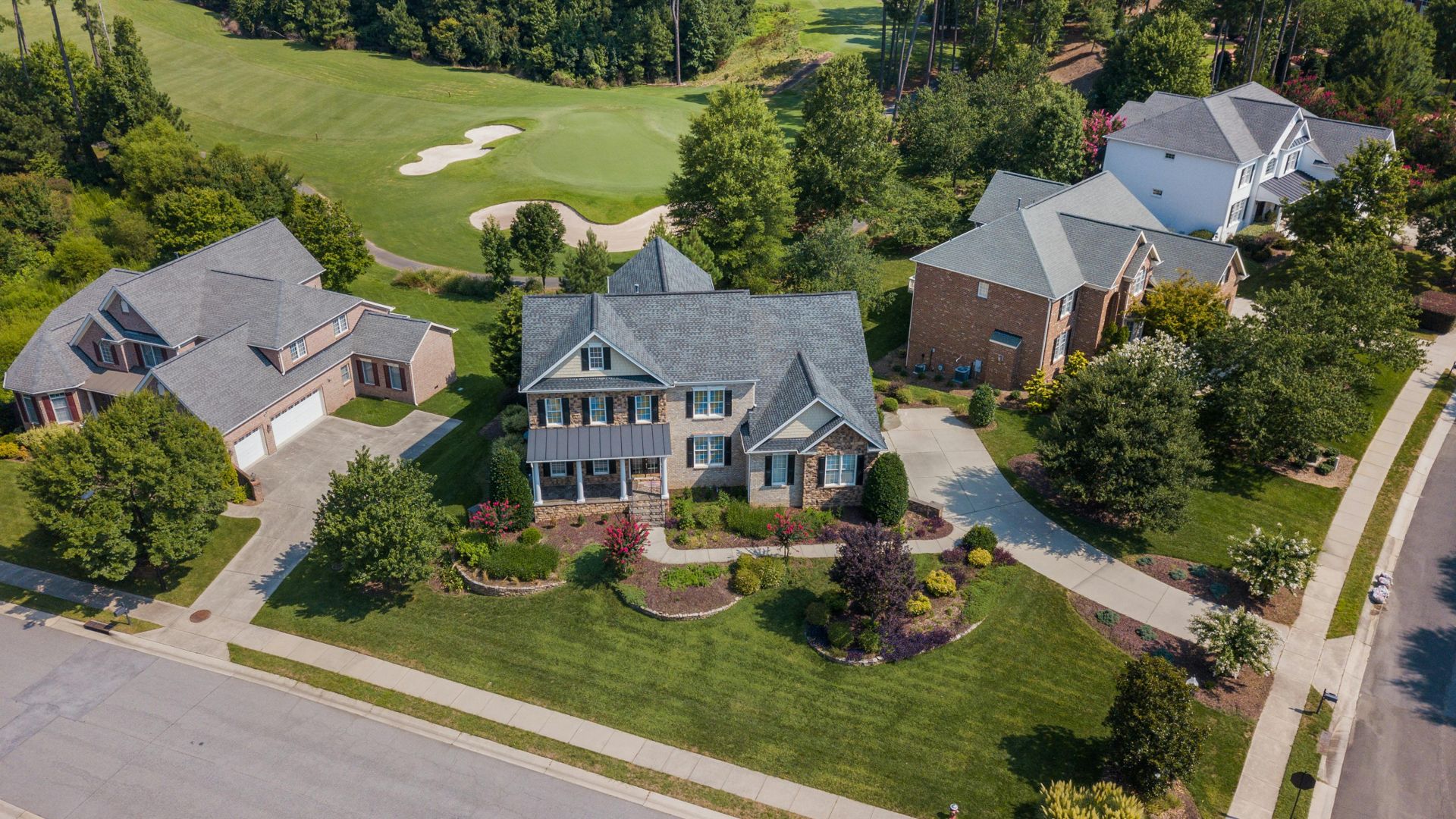 Aerial shot showcasing suburban homes and lush greenery in Raleigh, NC.