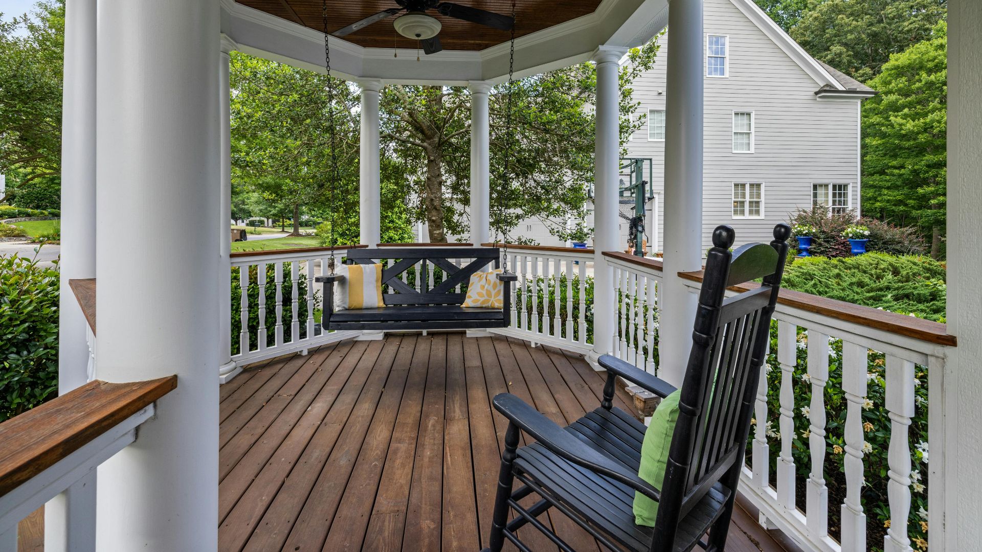 Inviting porch with rocking chair and swing, perfect for relaxation.