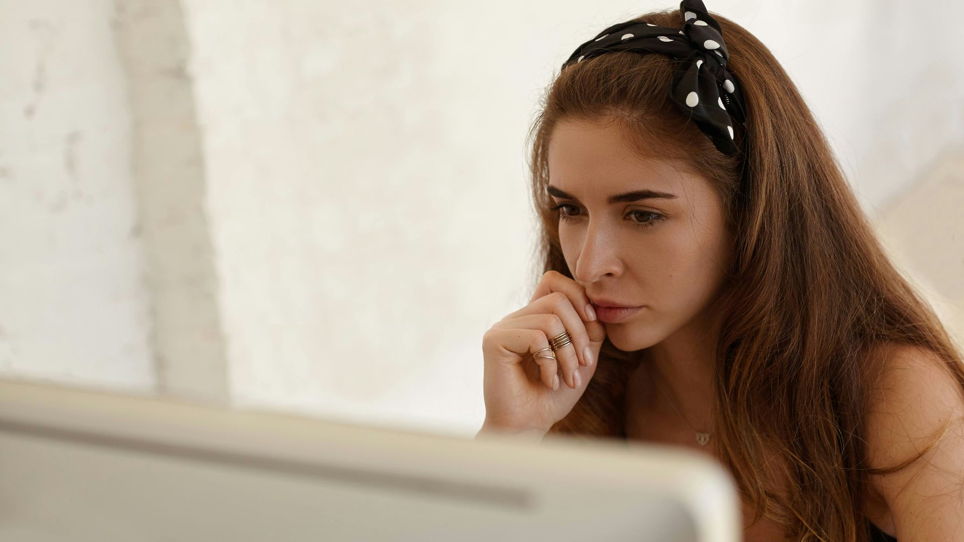 a woman sitting in front of a laptop computer