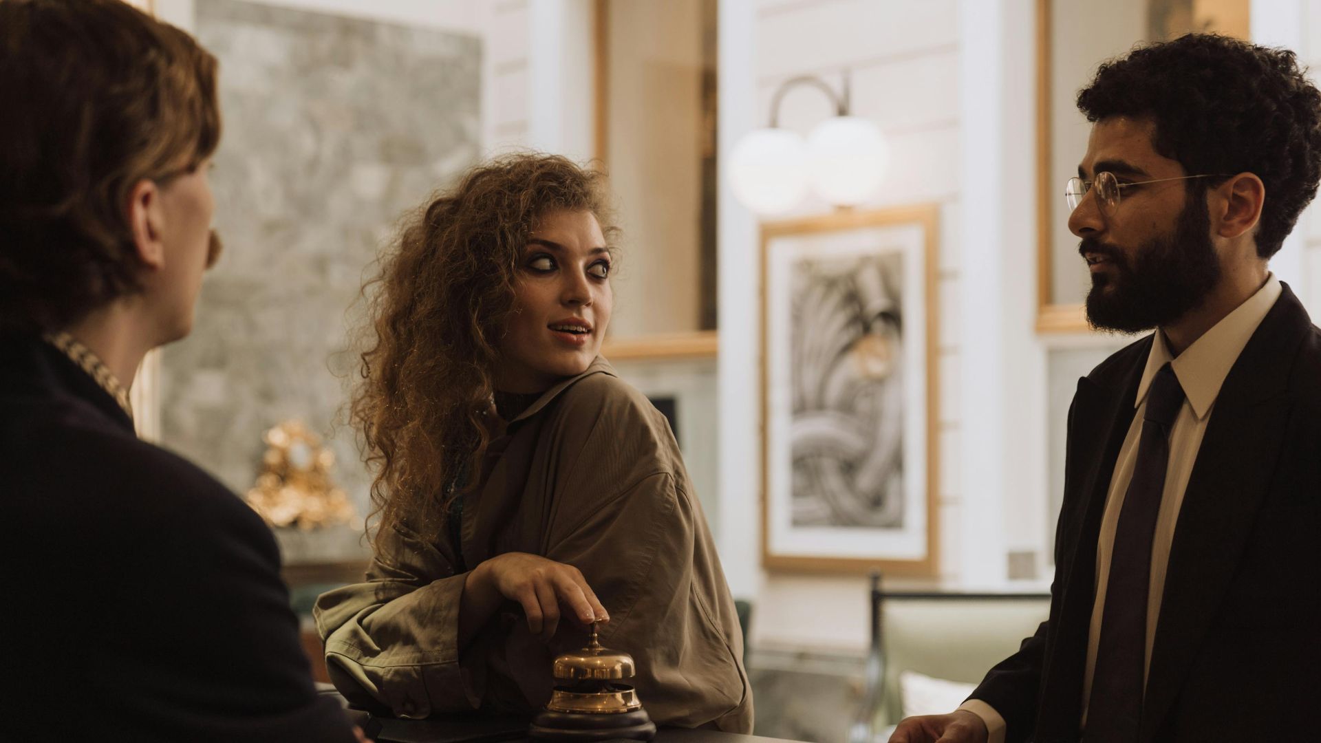 Guests interacting at a luxurious hotel reception desk, emphasizing hospitality and service.