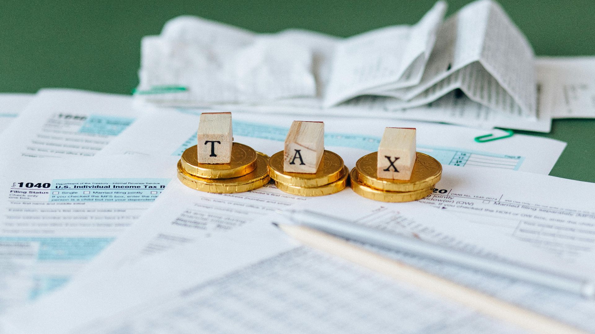 Close-up of tax forms, receipts, and coins symbolizing financial accounting and taxes.