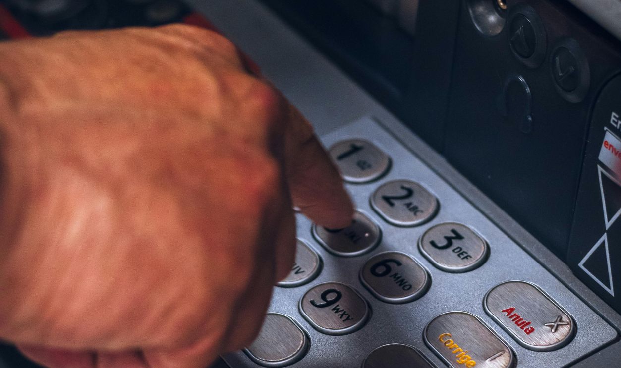 Person Pressing Keys of an ATM