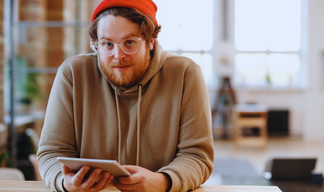 A Bearded Man Holding a Digital Tablet