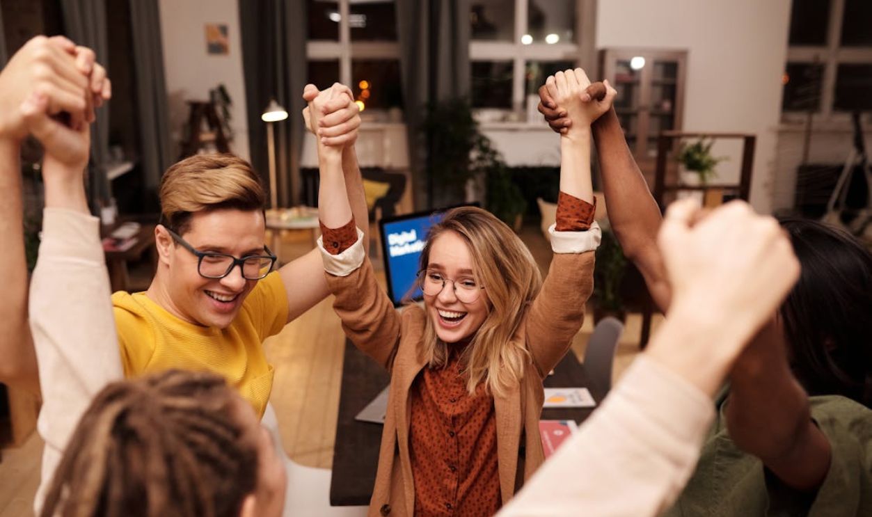 Woman in White Long Sleeve Shirt Smiling Beside Woman in Orange Scarf