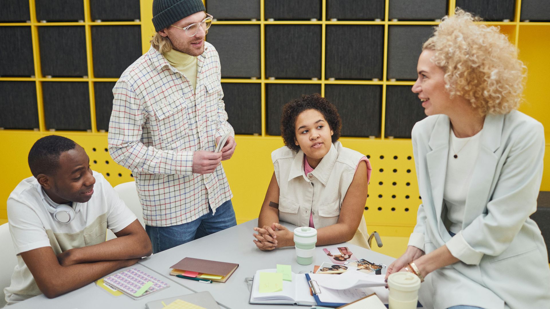 A diverse group of colleagues collaborating at a desk in a modern office setting.