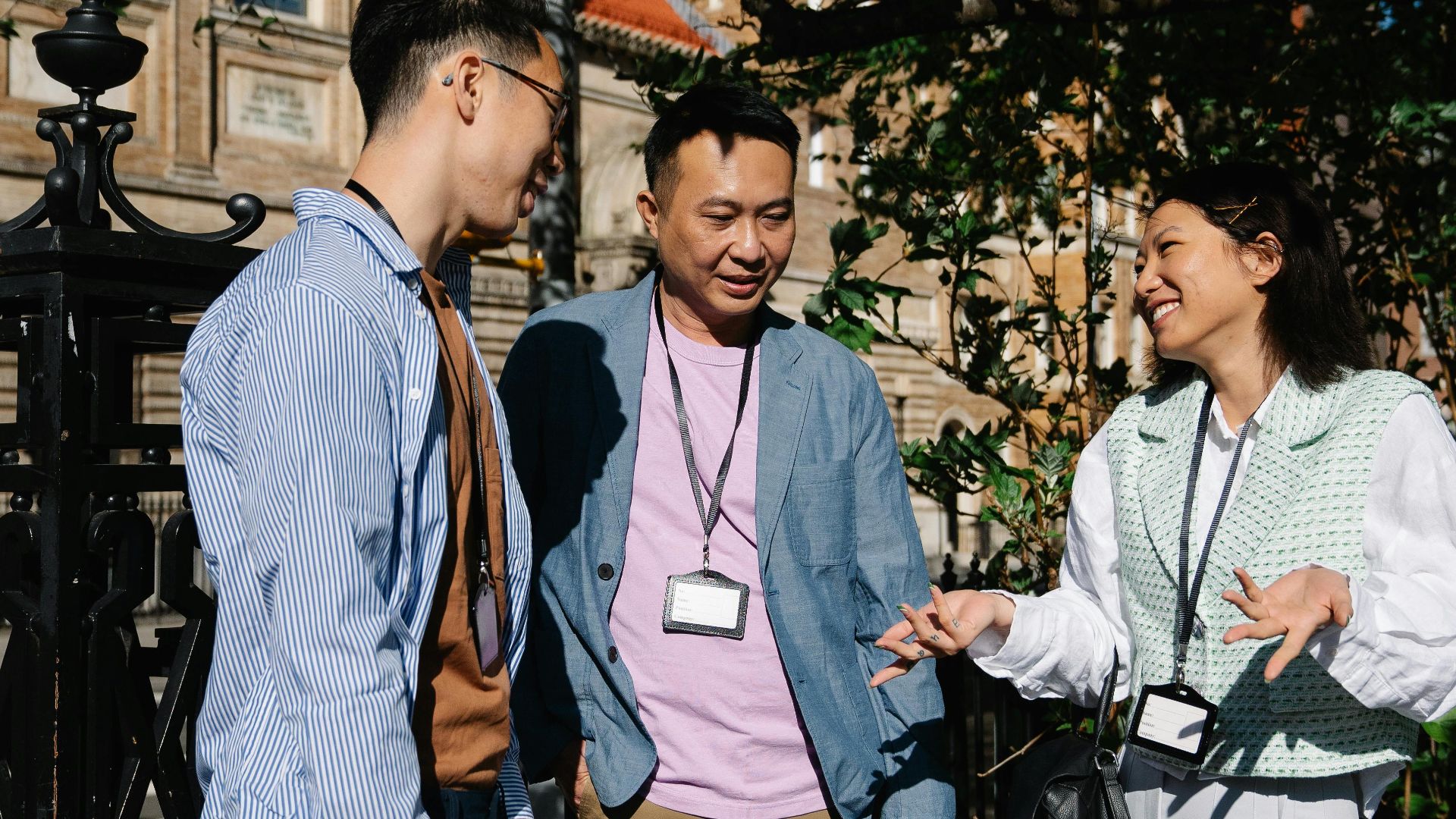 A group of colleagues engaging in a friendly conversation outdoors during a break.