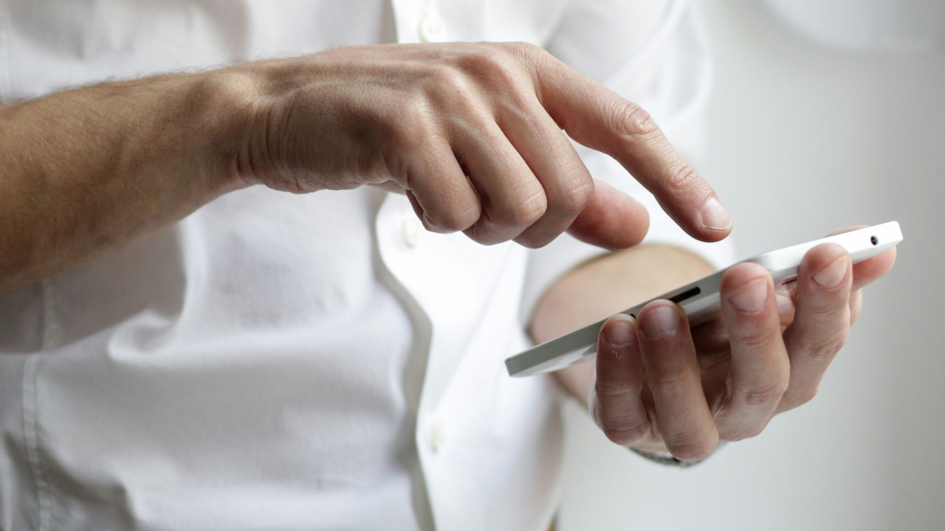 person holding white Android smartphone in white shirt