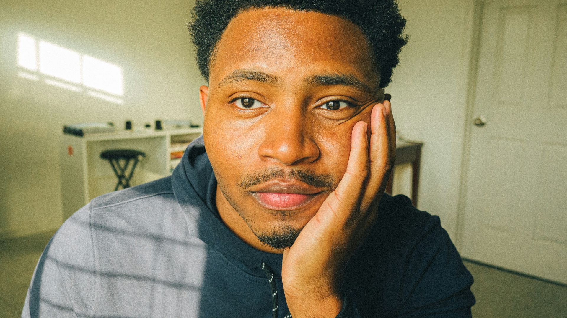 a man with his hand on his face