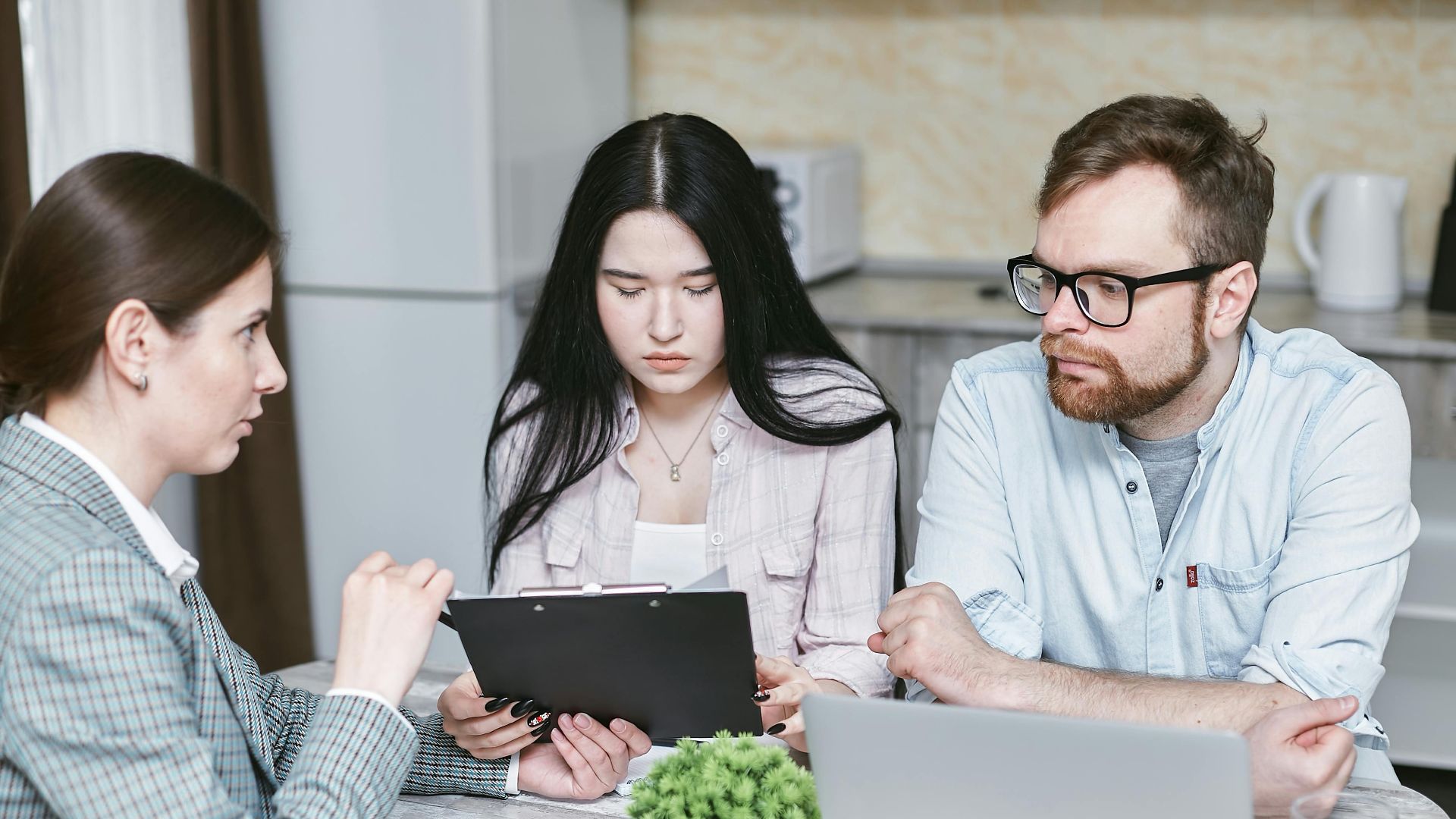 A group of professionals discussing business strategies at a table indoors.