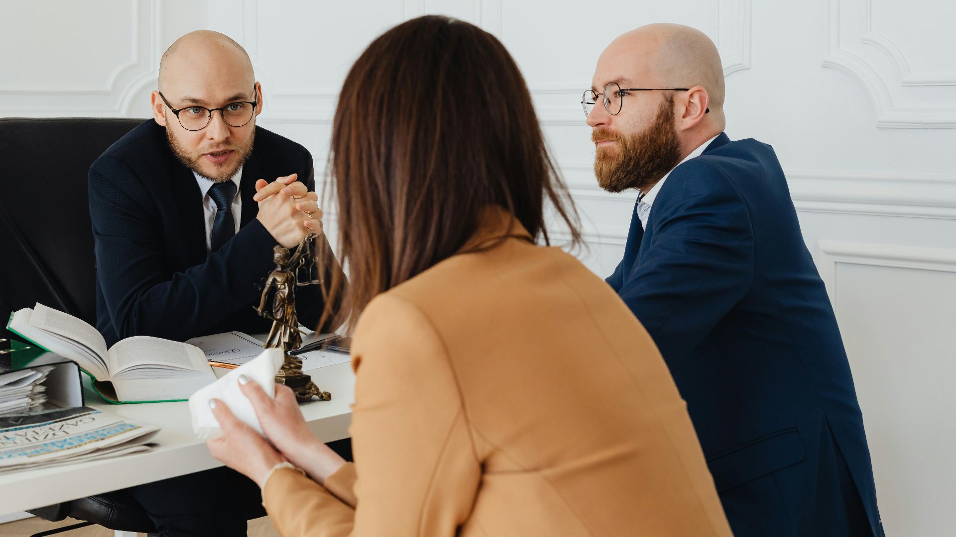 Professional discussion among lawyers in a modern office, focusing on legal matters.