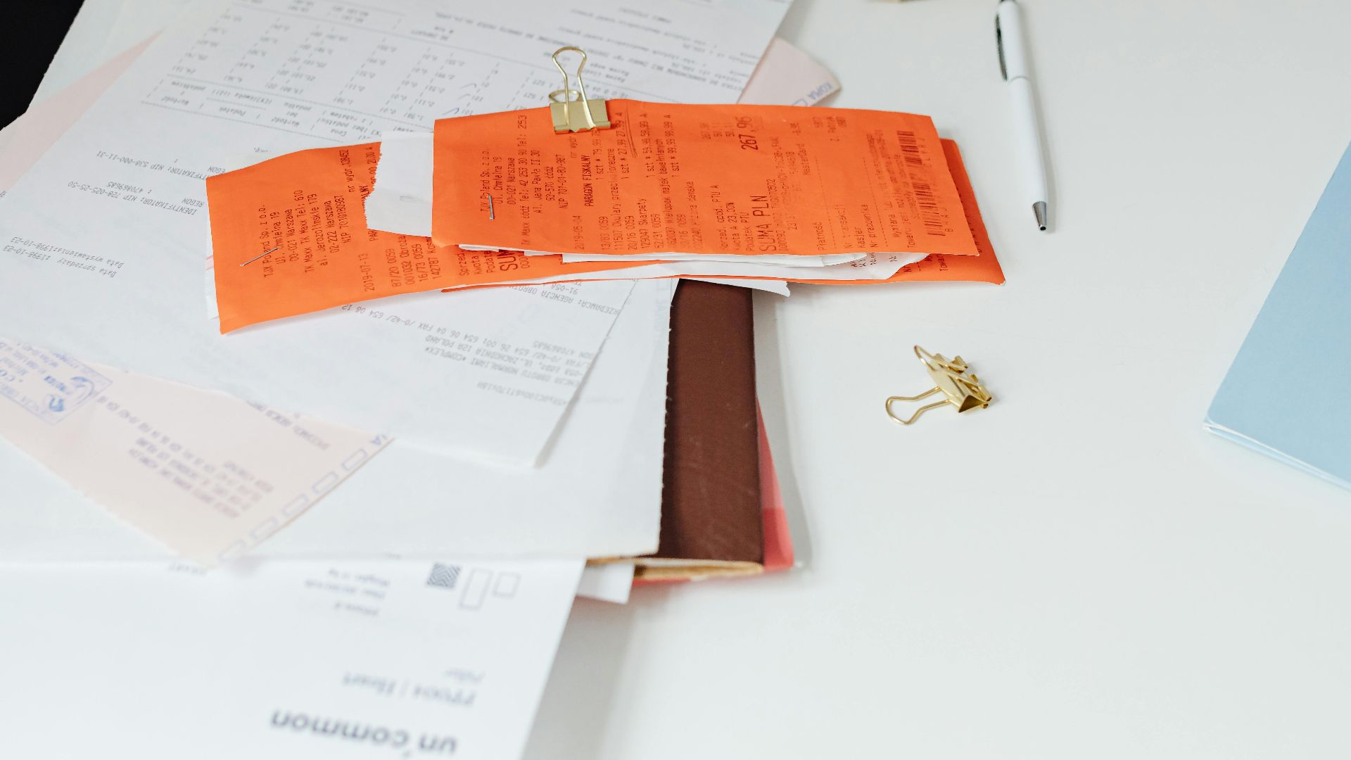 Close-up of a tidy desk with receipts, documents, and office stationery for business organization.