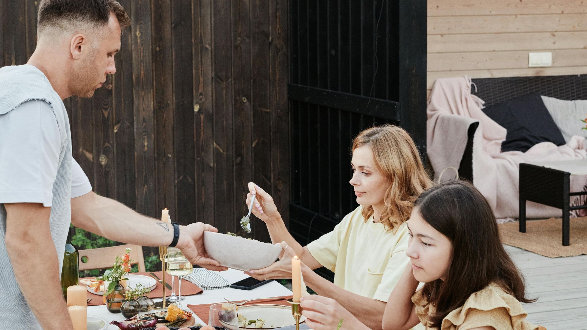 Family dining outdoors, sharing a meal and enjoying quality time together.