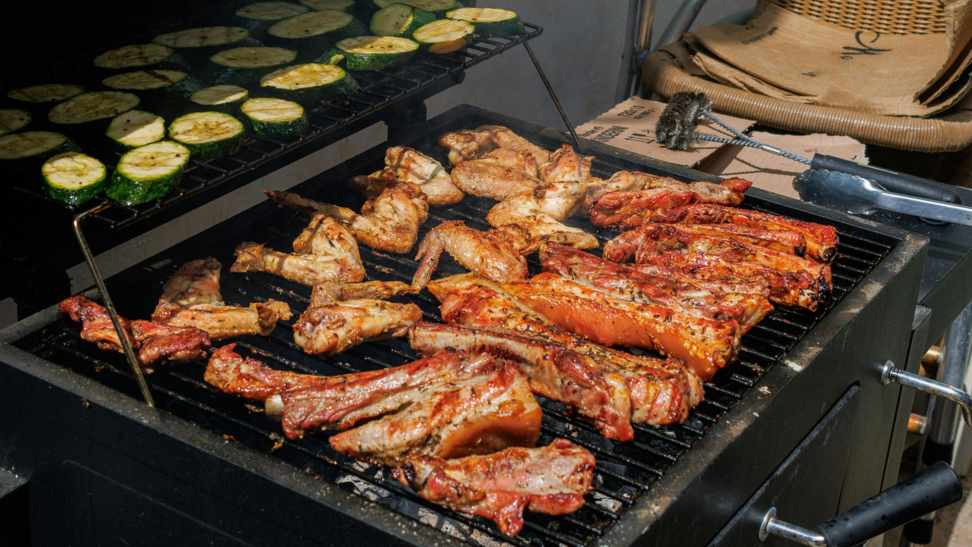 A backyard barbecue with grilled meats and vegetables on a sunny day, perfect for outdoor gatherings.