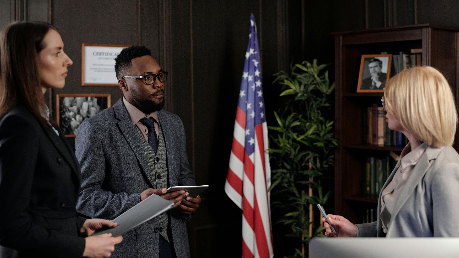 Business professionals in formal discussion, advocating teamwork and diversity.