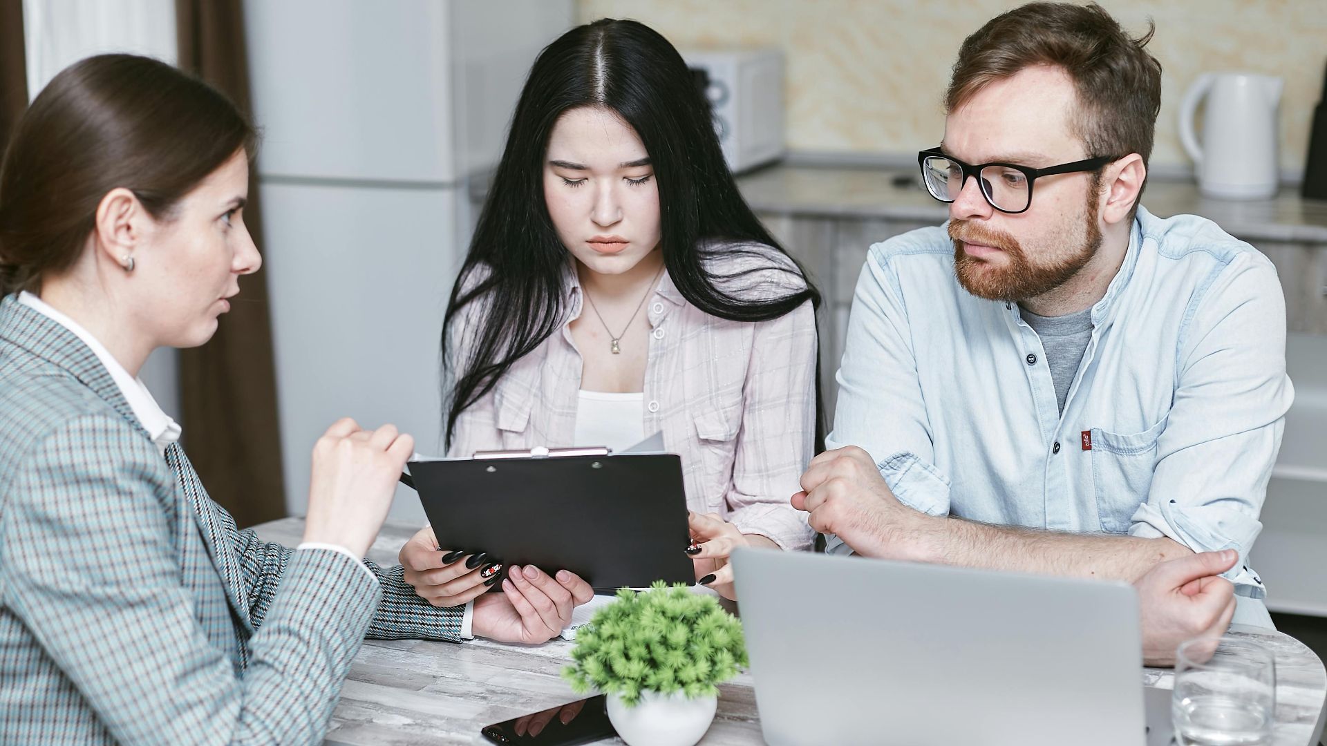 A group of professionals discussing business strategies at a table indoors.