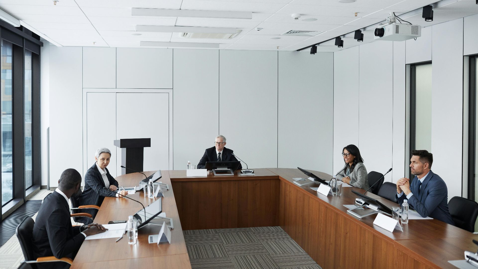 Multicultural business team in a conference room discussing strategies.