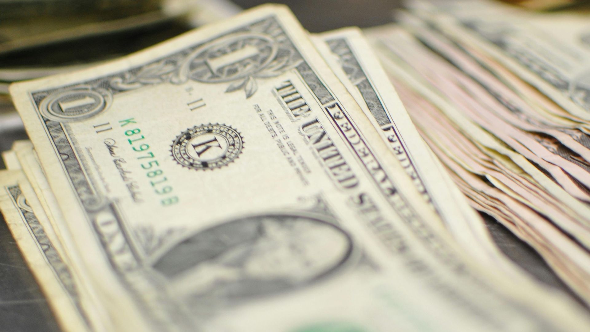 Close-up of US dollar bills in a stack suggesting finance and currency.