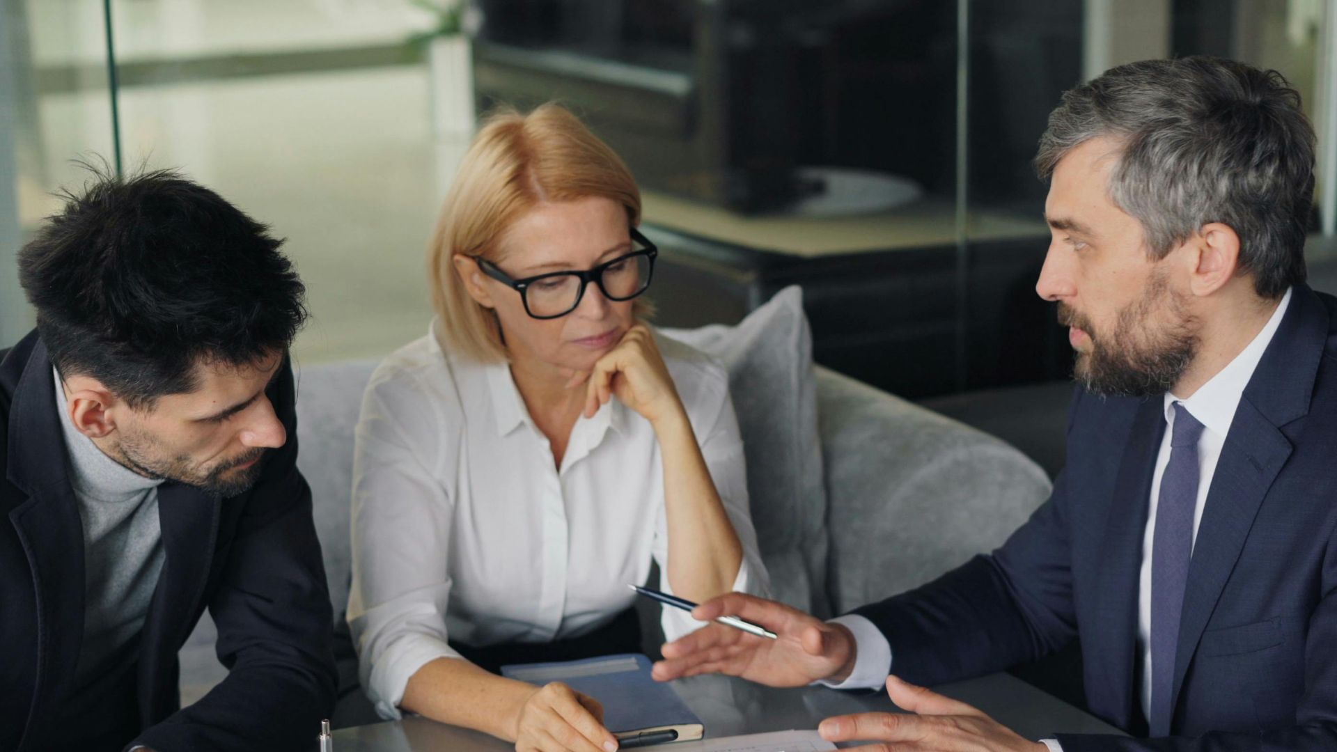 Professional colleagues engaged in a business meeting discussing strategy over coffee.