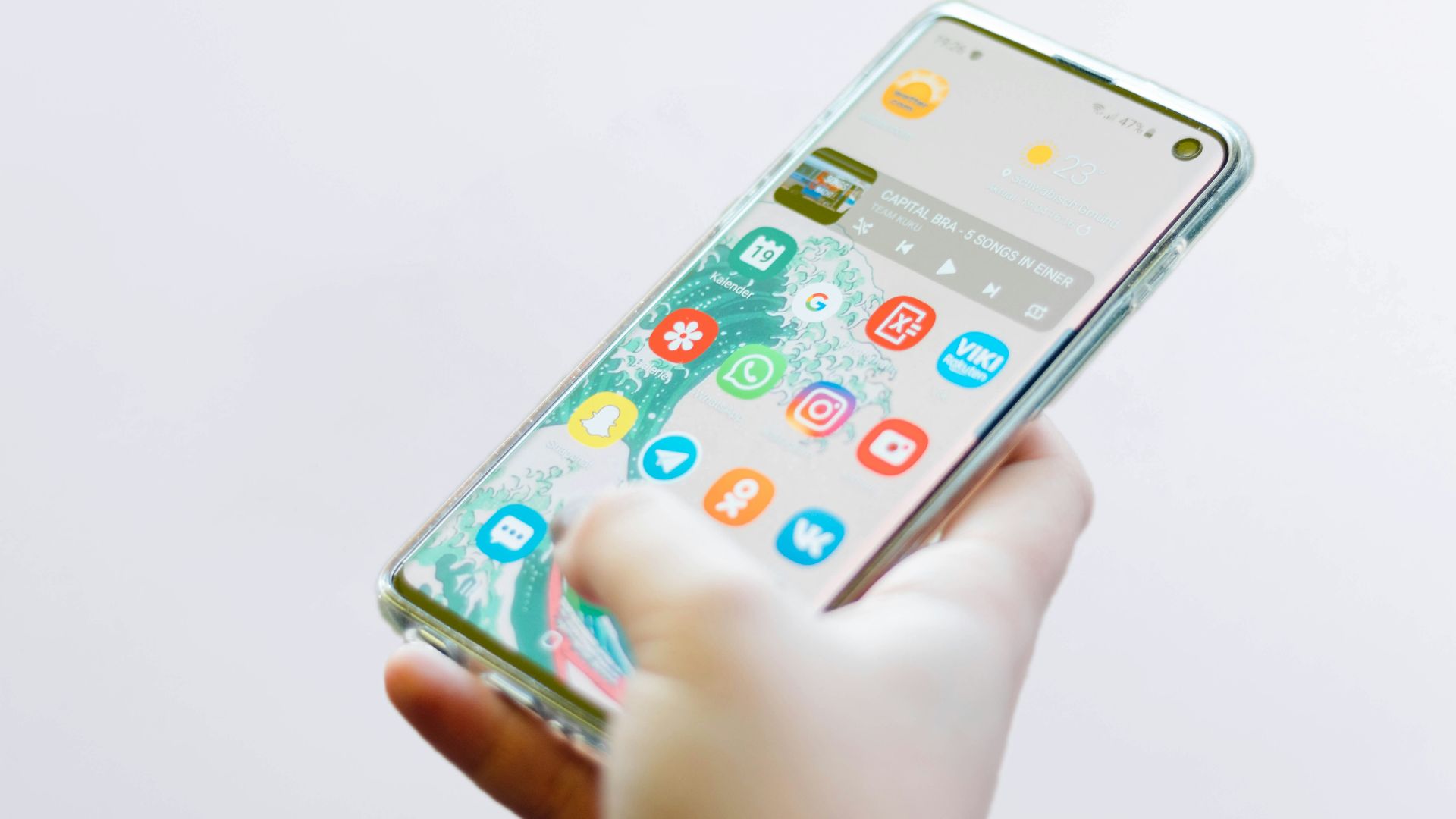 person using silver Android smartphone