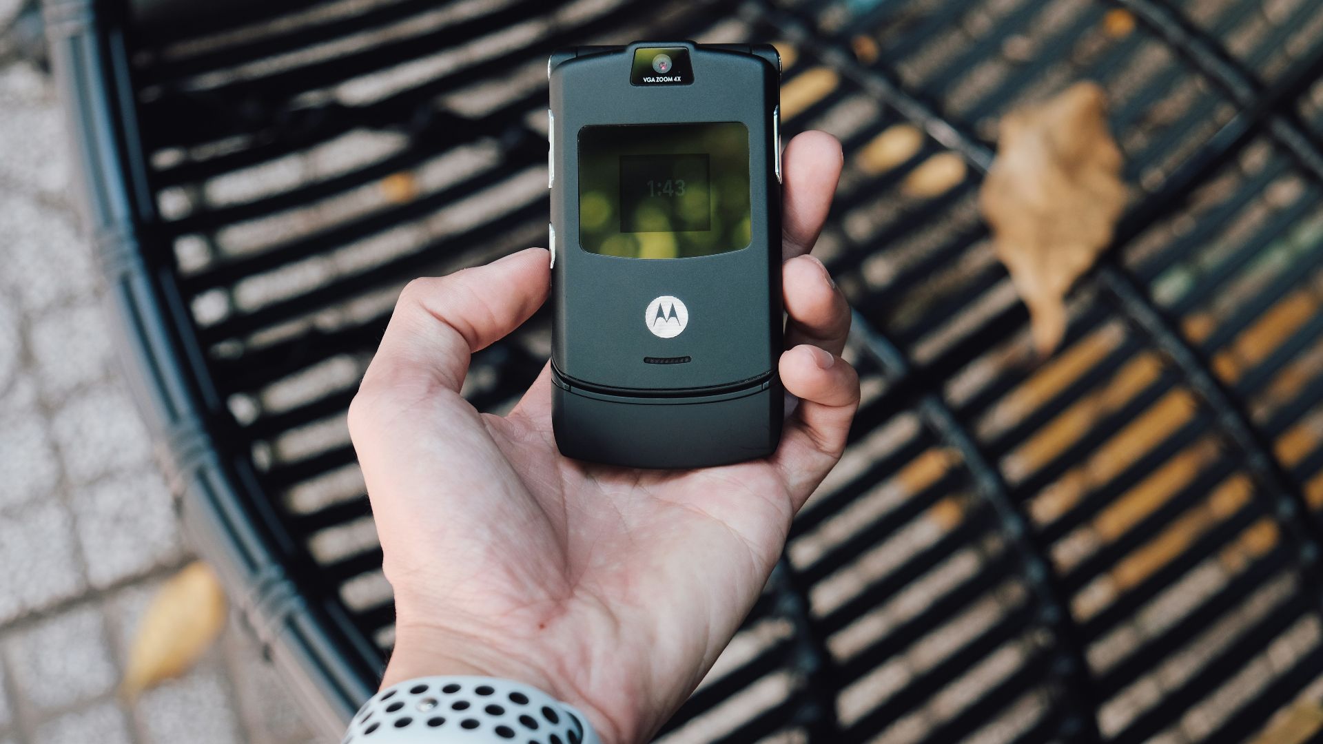 black samsung flip phone on persons hand